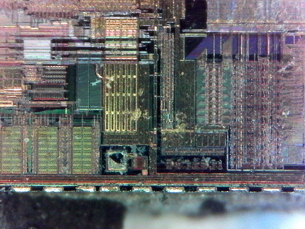 A different region of the chip showing different types of circuitry. The marking "DS3231" is clearly visible in the bottom-center, though there is an unknown marking between the "32" and "32".